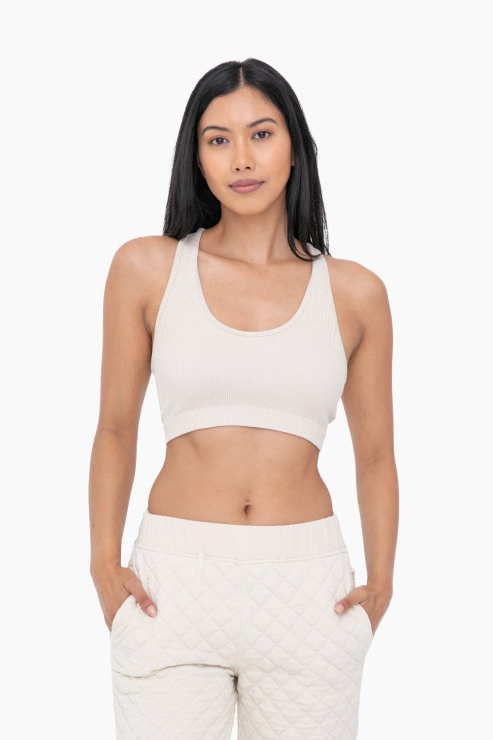 This Seamless Lounge Sports Bra offers an extra cozy fit with its ribbed and racerback design. With no pesky seams to hold you back, this lightweight bra will help you move comfortably and freely. Perfect for lounging and light exercise.      92% Polyamide, 8% Elastane,     Machine wash cold, Hang dry.