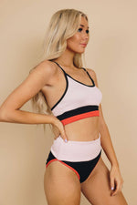 -Color Block Bikini Set-  We love the color block because it's a two piece that covers moderately. The shoulder straps are adjustable. Removable cups. This fabric is so soft ans stretchy. The high rise bottoms fit just right!   Small (2-4), Medium (6-8), Large (10-12), XL (12-14)