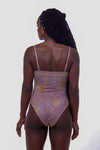 Back View _Our Forever Wild Amelia One Piece Swimsuit is exactly what you need for your next vacation! This swimsuit is a new take on leopard print that incorporates unique colors from violet to orange hues to create a stunning pattern. With mid-cheeky coverage, you'll have enough support for comfort without sacrificing style. This one-piece is the perfect one and done look for your next beach outing!