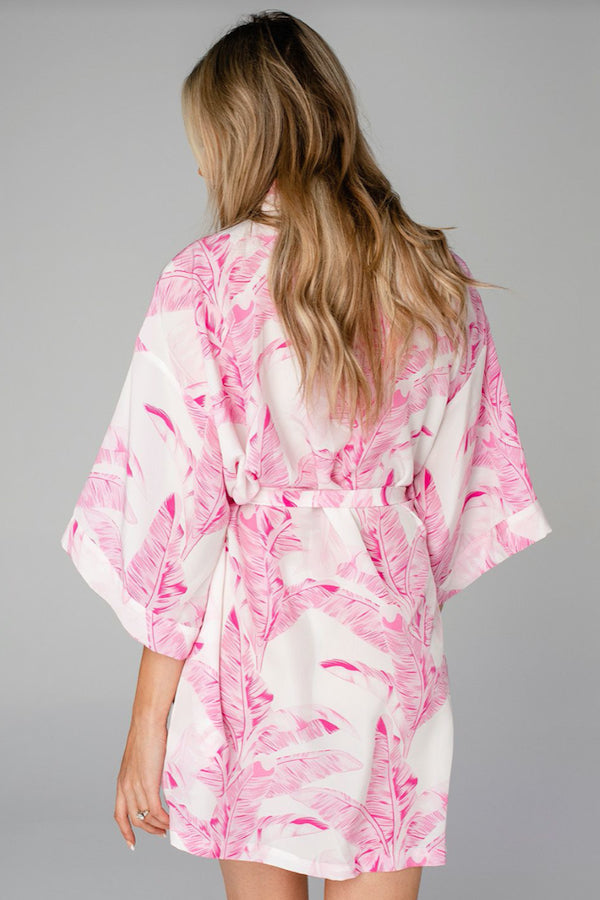 -Tropical Pink Palm Robe-  Our robe recently got an upgrade to a buttery silky fabric that we absolutely LOVE. This is a luxe satin-like material with kimono style short sleeves, tie closure and a perfect fit. This robe is a great gift to or treat yourself as part of your self care ritual.  One Size 33" in length. 100% Polyester. Machine wash cold and hang dry.