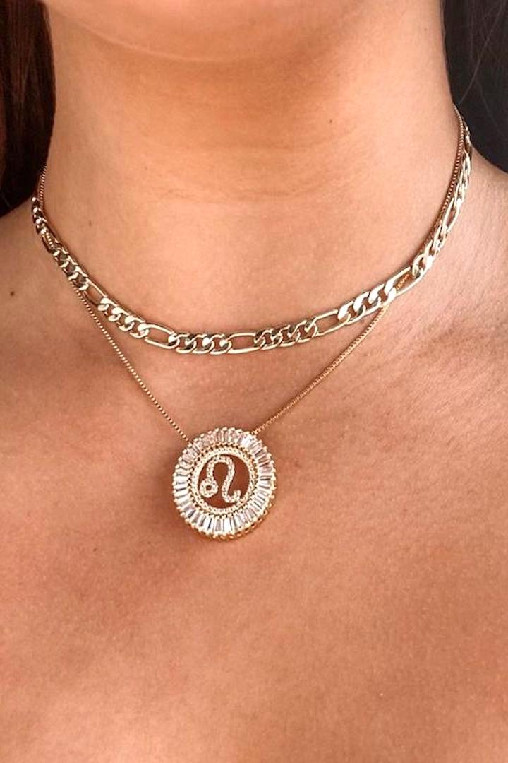 -Zodiac Radiant Necklace-  No one has to guess whether your are an emotional Cancer or a stubborn Taurus. We love these necklaces and they are available in your sign!   18k gold plated brass with clear crystals, 16” length with 1” extension, Zodiac pendant is 1.5” in diameter.