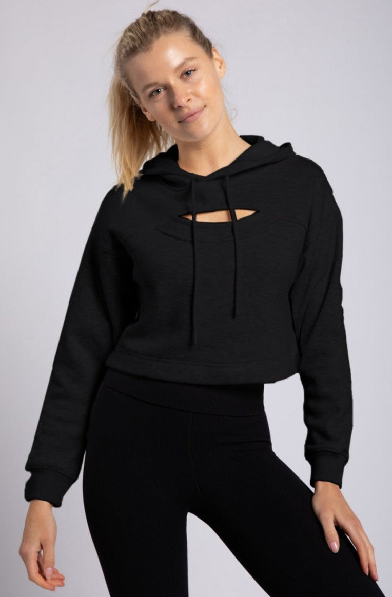 Women's cropped hoodie with brushed fluffy lining, peek a boo opening at chest just enough to show a little skin with banded wrist. Hoodie has drawstring closure and loose fit. Pair with leggings or jeans for a comfy cozy look.